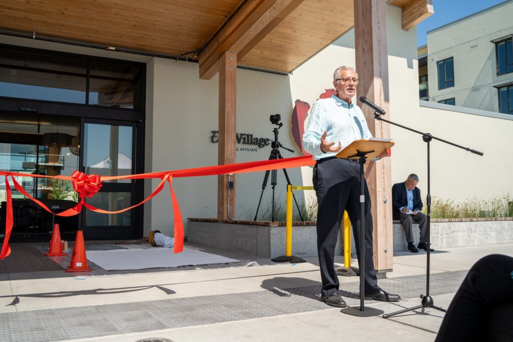 Man giving speech next to entrance