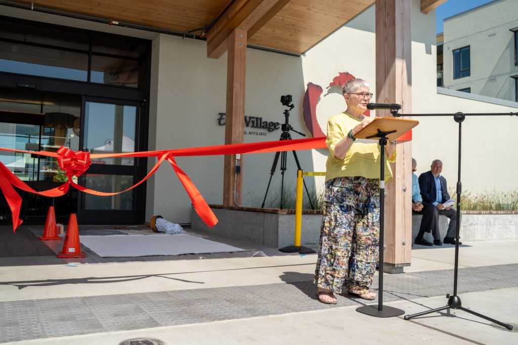 Woman giving speech next to entrance