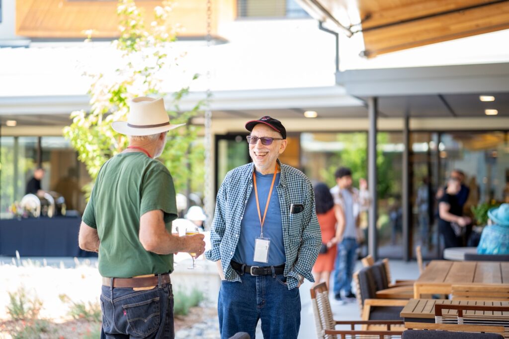 Two men happily conversing