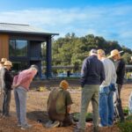 Kitchen Garden Manager, Aris Curtis, holds a brief meeting before planting the garden