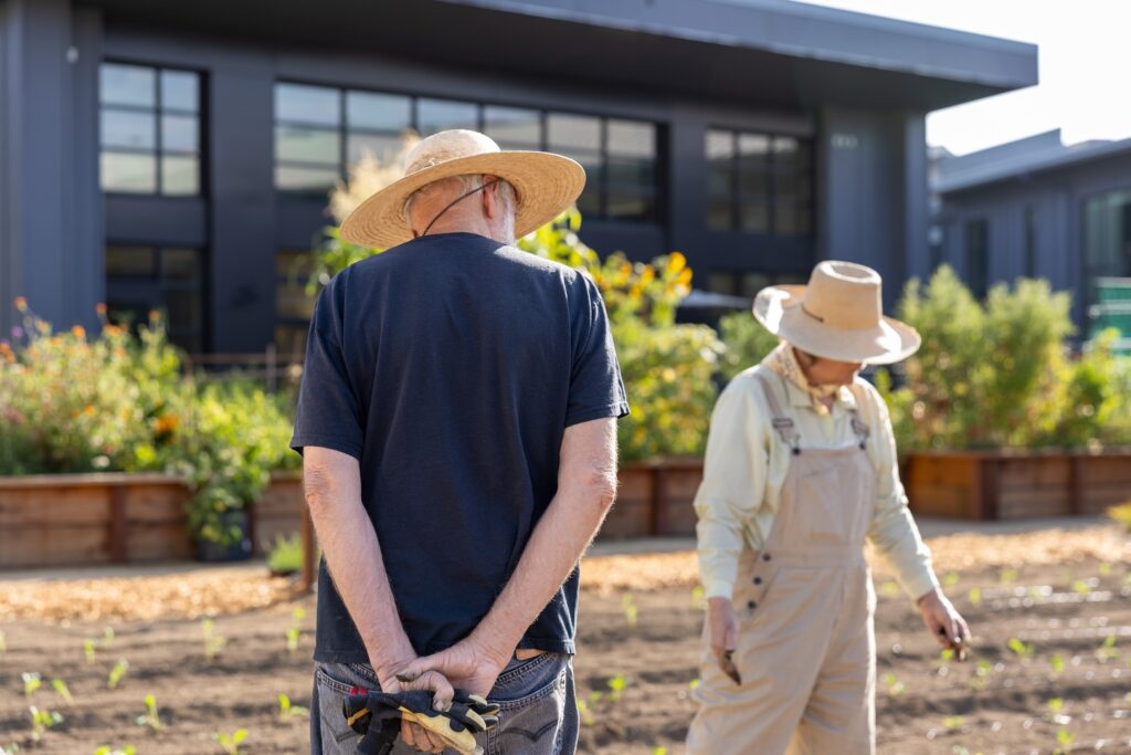 Two residents standing in the kitchen garden