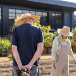 Two residents standing in the kitchen garden