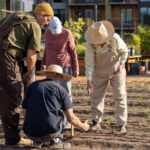 Kitchen Garden Manager, Aris Curtis, works with residents on planting positions